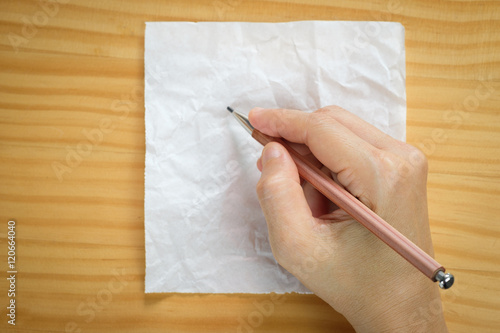 Woman writing on blank paper sheets