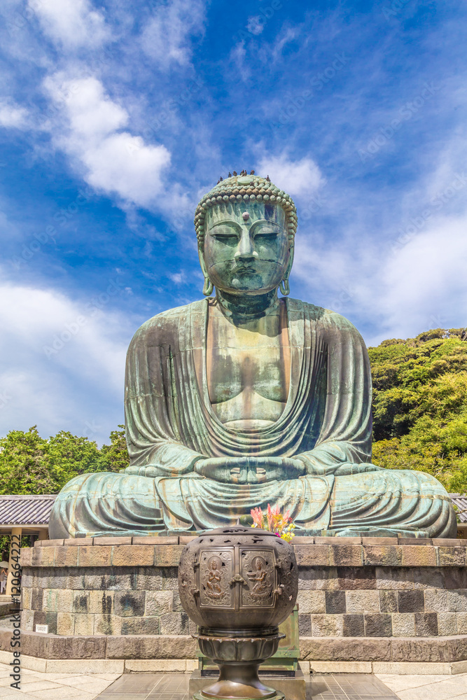The Great Buddha in Kamakura. Pigeon is resting on top of the Buddha's head. The Great Buddha in Kamakura. Pigeon is resting on top of the Buddha's head.