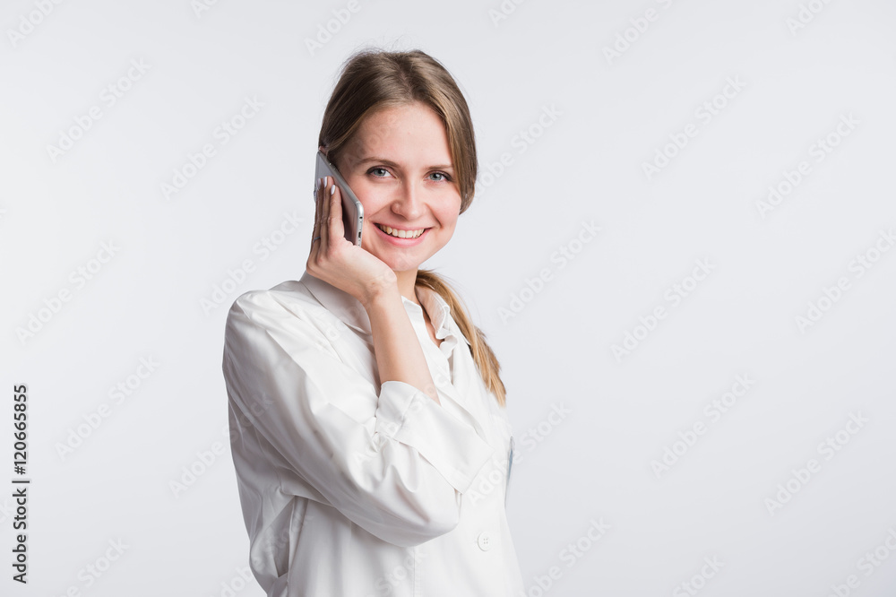 Female doctor talking on the cell phone isolated over white background Female doctor talking on the cell phone isolated over white background