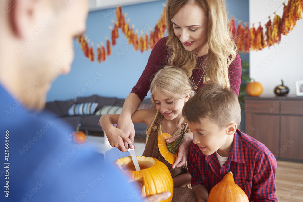 Fototapeta premium Family working on Halloween pumpkins