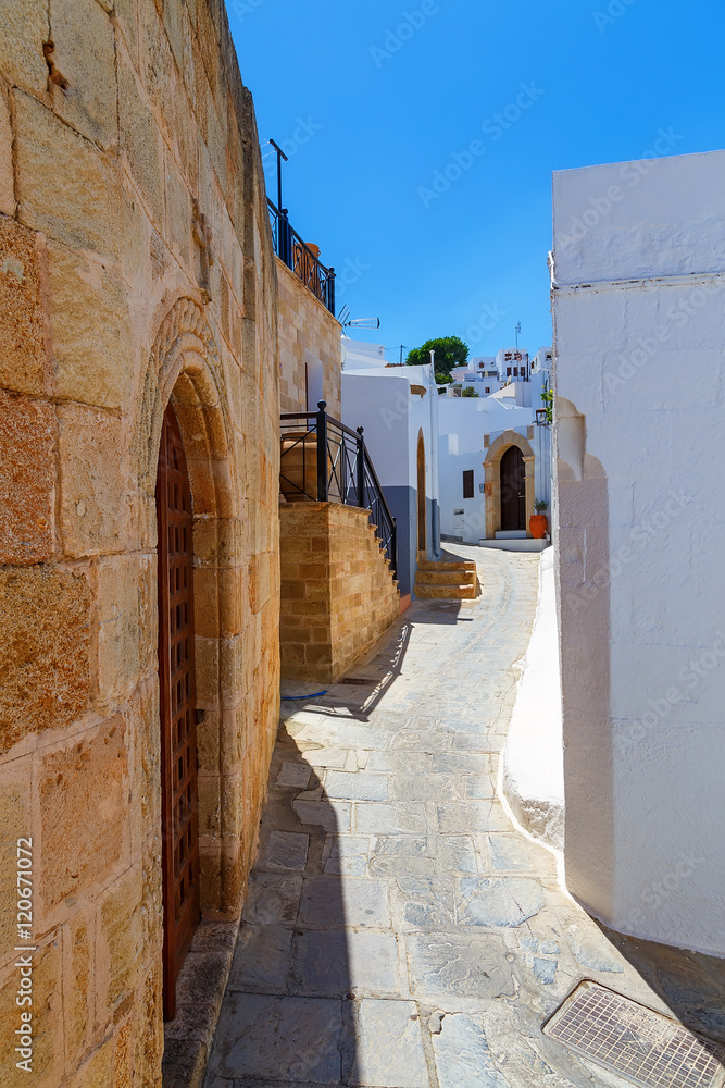 Traditional street with white houses in Lindos village, Rhodes island, Dodecanese, Greece.