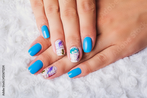 Light blue nail art with feathers print
