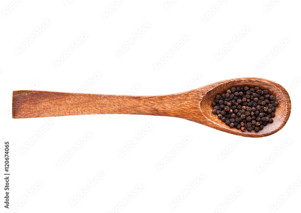 Black pepper on wooden spoon isolated on white background Black pepper on wooden spoon isolated on white background