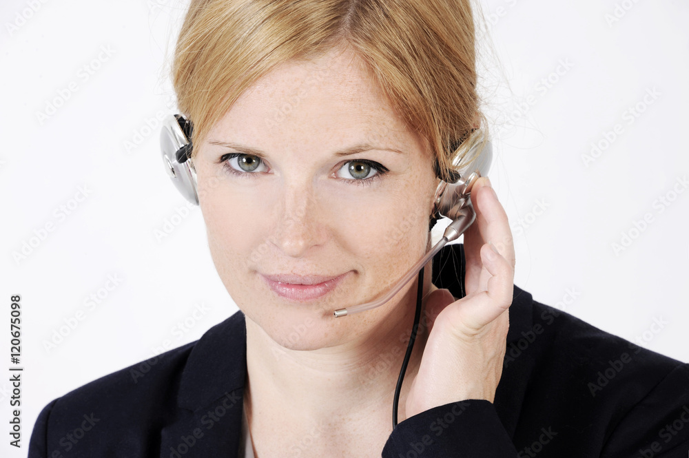 Portrait of a nice freckled face woman in a call center with phone headset. Studio shot isolated on light background. Portrait of a nice freckled face woman in a call center with phone headset. Studio shot isolated on light background.