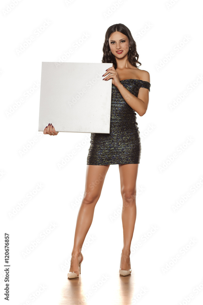 beautiful and pretty brunette in a short dress holding a blank board beautiful and pretty brunette in a short dress holding a blank board