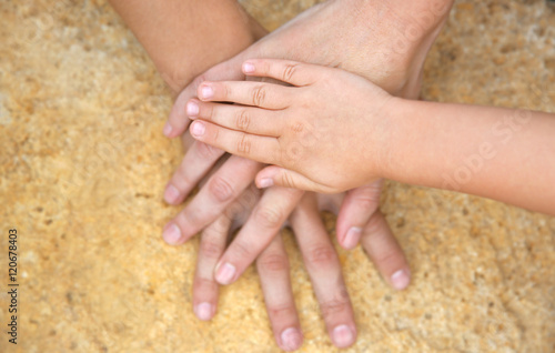 Family hands on stone background