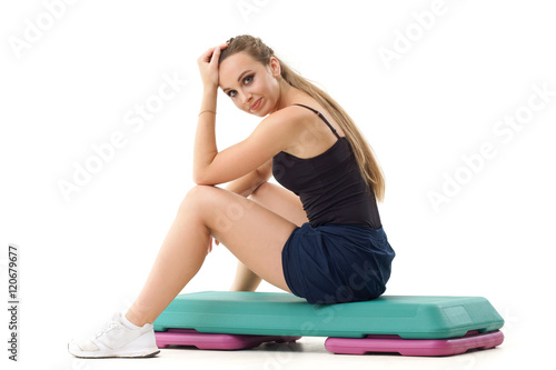 Concepts: healthy lifestyle, sport. Happy beautiful woman fitness trainer working out step aerobics isolated on white background