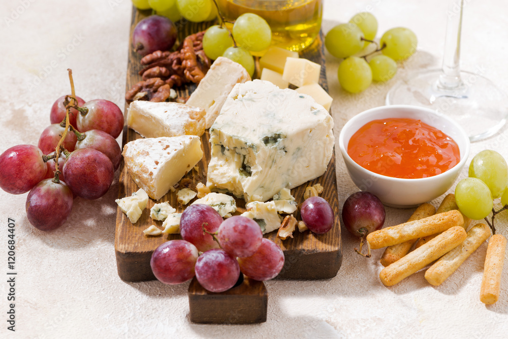 cheeseboard, fresh grapes and honey on a white background cheeseboard, fresh grapes and honey on a white background