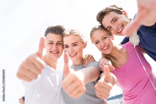 Friends showing thumbs up sign 
