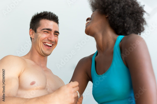 Photo of attractive couple at the gym. Coach measured body of be