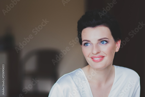 Portrait of beautiful healthy young brunette woman in a white spa bath robe