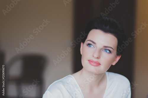 Portrait of beautiful healthy young brunette woman in a white spa bath robe