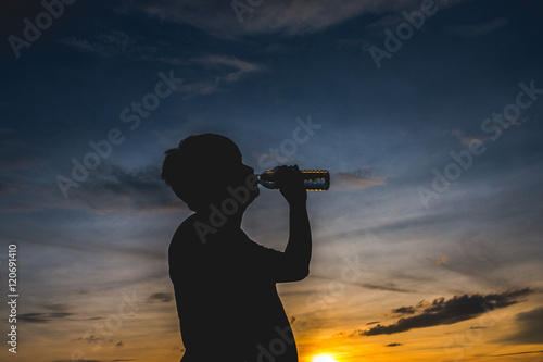 Silhouette with man's drinking water
