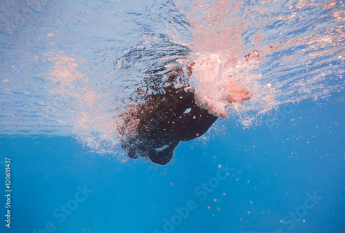 businessman swimming underwater