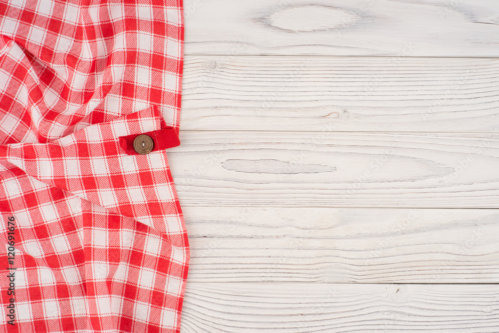 red folded tablecloth over bleached wooden table. red folded tablecloth over bleached wooden table.