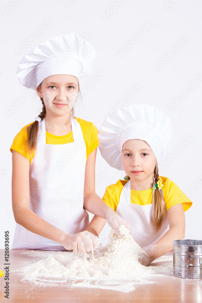 Children make the dough in the kitchen, roll a rolling pin Children make the dough in the kitchen, roll a rolling pin