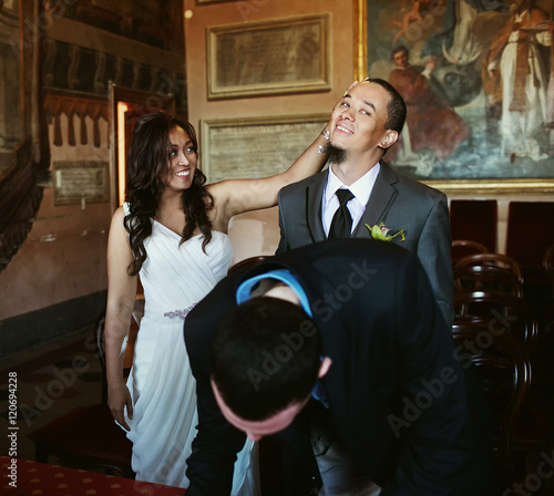 Happy newlyweds in the hall photo