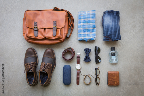 Men's casual outfits with accessories on gray grunge flat lay background