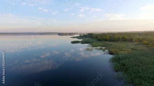 Sunrise at summer time lake and green forest, sand and reflection in water, Poland lanscape. View from above. photo