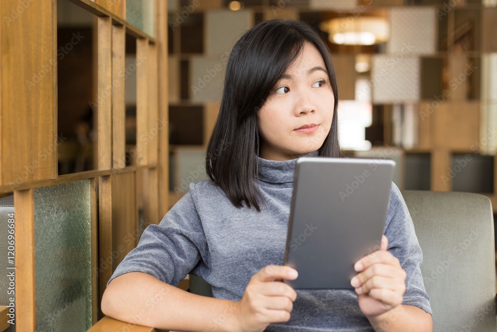 Woman using tablet in a coffee shop Woman using tablet in a coffee shop
