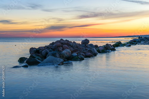 A ridge of boulders in the water on the Baltic sea coast, Zelenogradsk, Kaliningrad region of Russia. Dawn