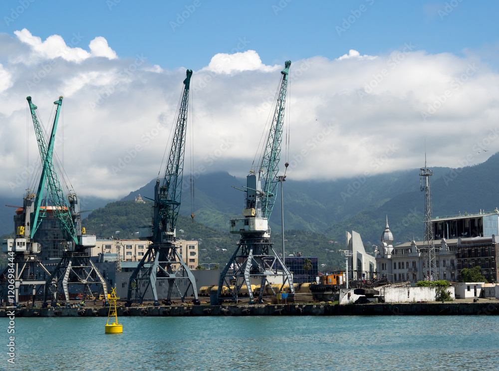 Cargo and transportation industry - cargo shipping and commercial terminal in seaport Batumi, Georgia. Industrial landscape with gantry cranes in a sea port.