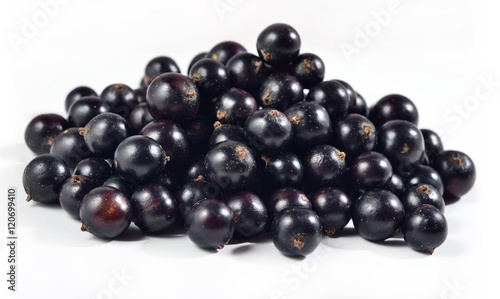 Heap of fresh black currant close up on a white