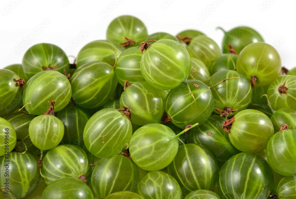 Heap of fresh green gooseberry close up on a white Heap of fresh green gooseberry close up on a white