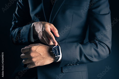 Businessman checking time from watch