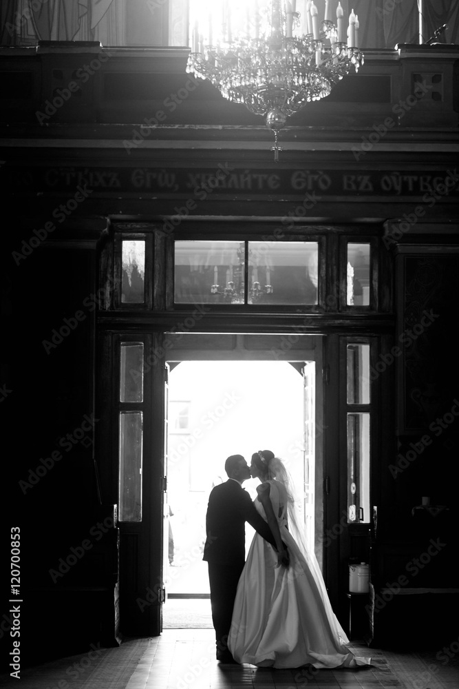 beautiful and young couple kiss each other at the door