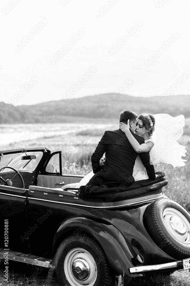 beautiful and happy husband and wife kissing in a car beautiful and happy husband and wife kissing in a car