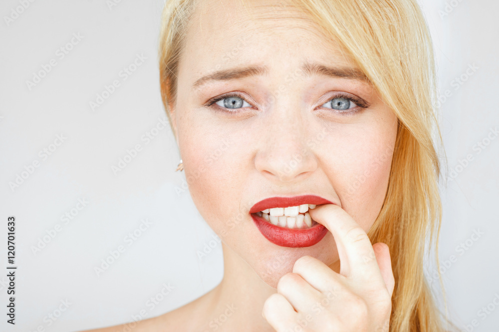 Beautiful red woman with confused look portrait. Young carroty girl with freckles feels at a loss. Thinking female pondering over something and biting her finger. Beautiful red woman with confused look portrait. Young carroty girl with freckles feels at a loss. Thinking female pondering over something and biting her finger.