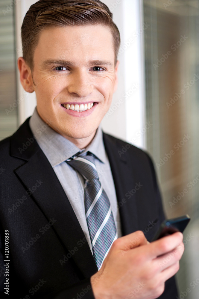 Fototapeta premium Businessman sending message in mobile phone.