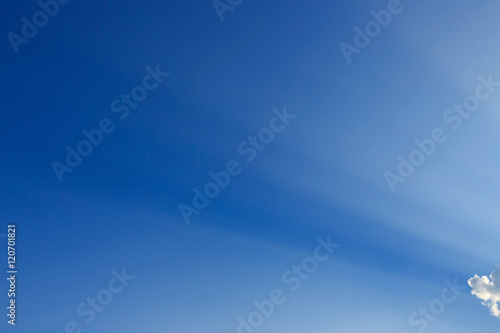 light rays on clear blue sky background