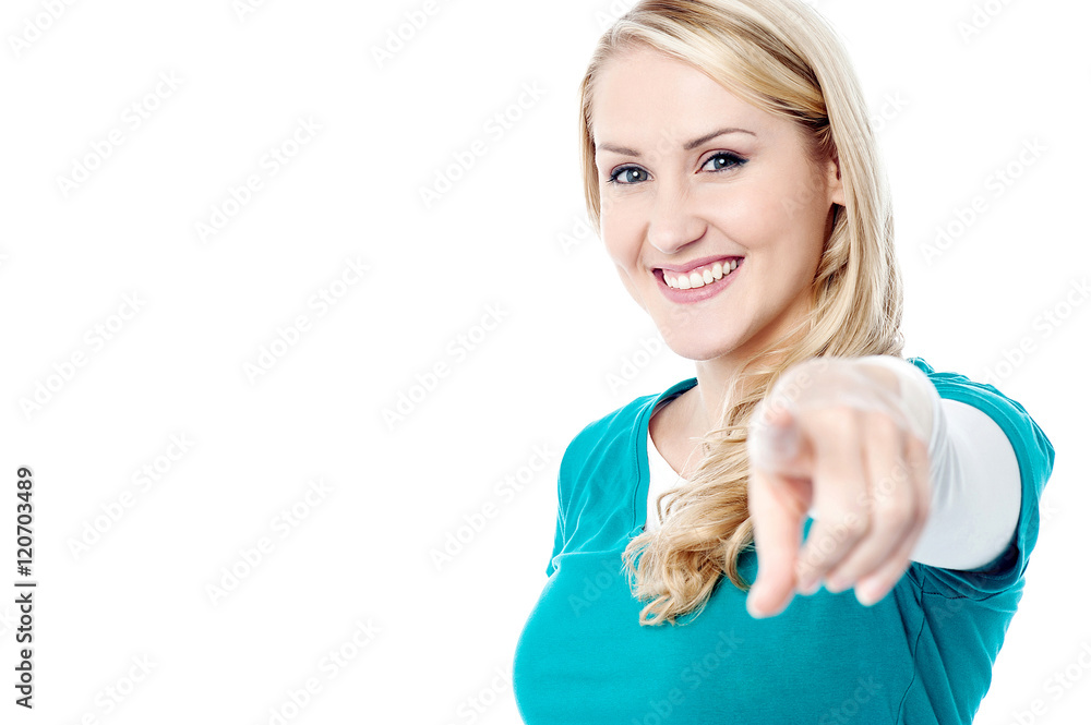 Fototapeta premium Attractive young lady pointing you out