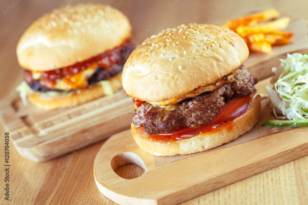 home made burgers on wooden background