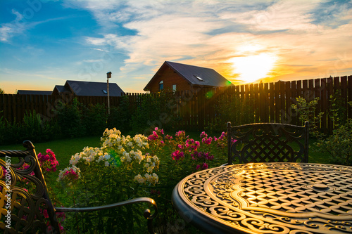 Country house garden at sunset time photo