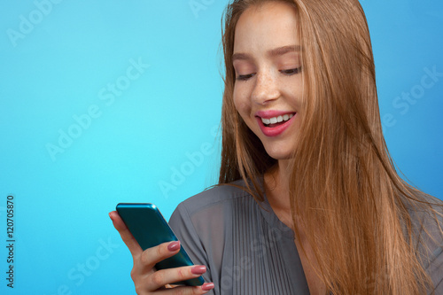 Beautiful young caucasian business woman with smart phone