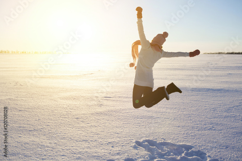 Happy girl with a red scarf on the winter background