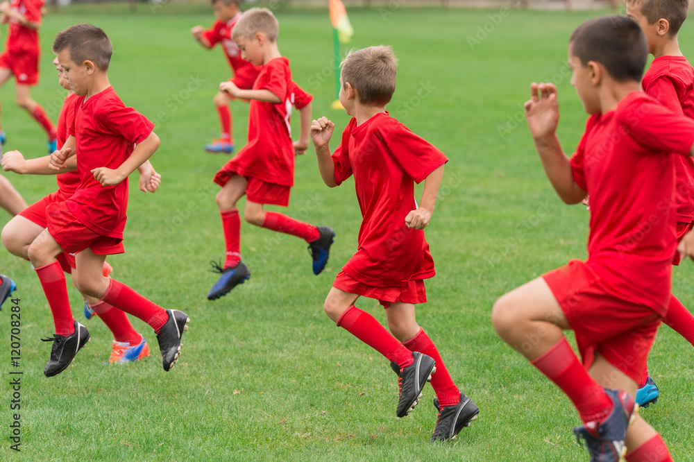 Obraz premium Boys kicking ball