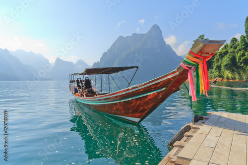 Long tail boat against mountain and lake