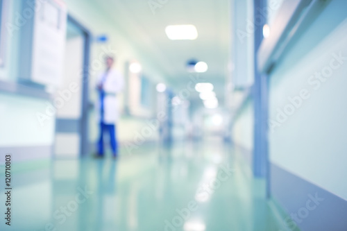 Doctor in hospital corridor, unfocused background