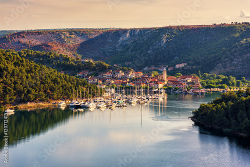 Small cozy town of Skradin on Krka river in a gentle morning light, the entrance to the Krka National Park, Dalmatia, Croatia photo