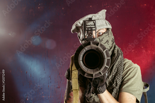 Portrait of man aiming through bazooka gun