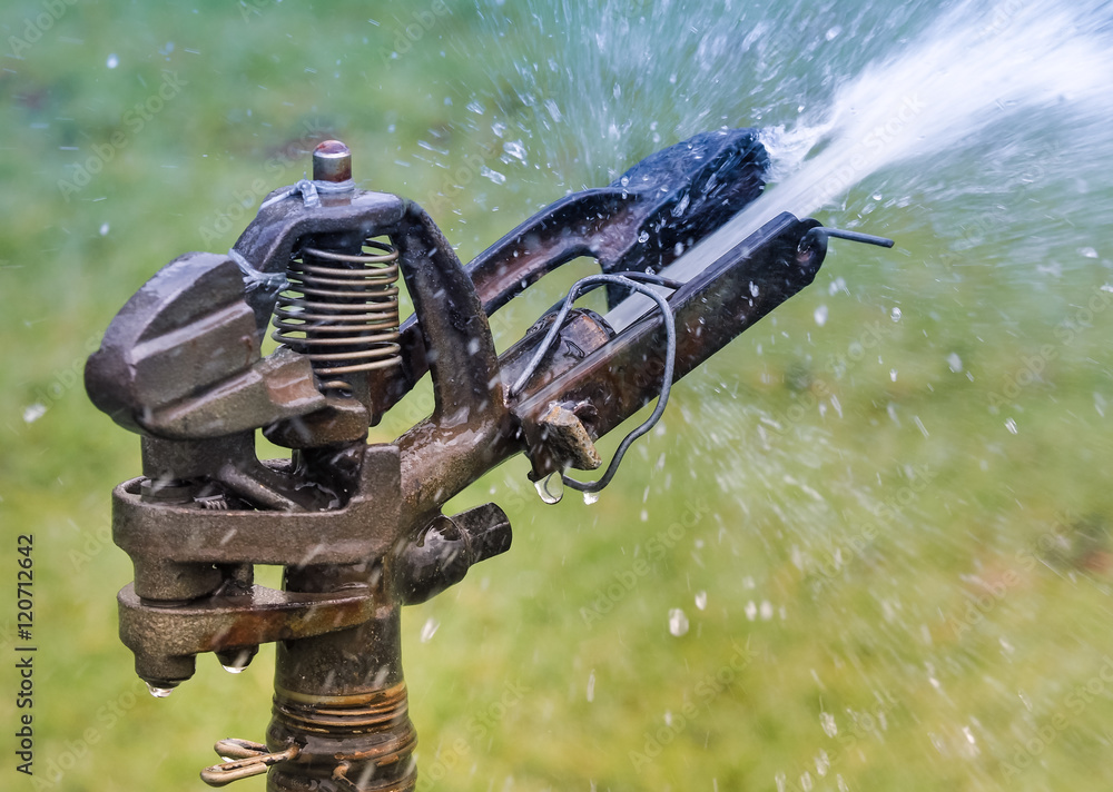 Old sprinkler water in the garden, Close up and selective focus Old sprinkler water in the garden, Close up and selective focus