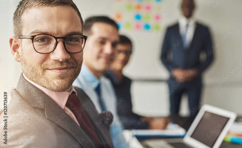 © Flamingo Images - Cute man in eyeglasses with co-workers in meeting