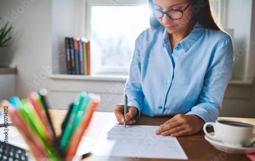 Young businesswoman busy writing notes