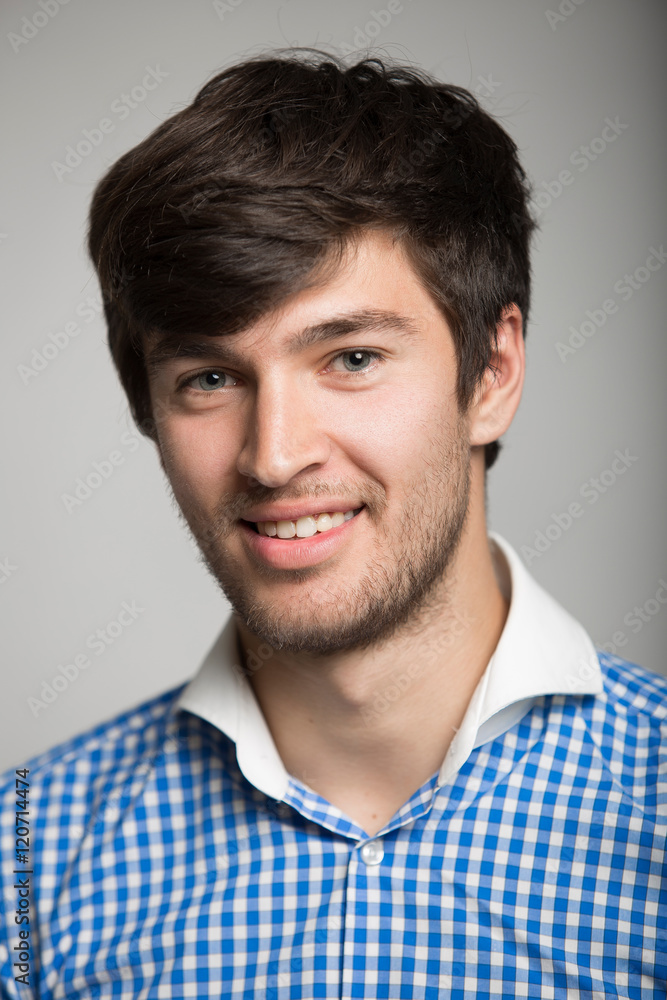Obraz premium a large portrait of a happy young man in a plaid shirt