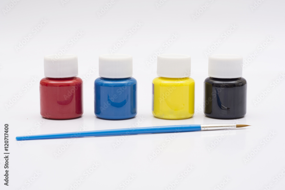 Four paint bottles in prime colors with painting brush Four paint bottles in prime colors with painting brush