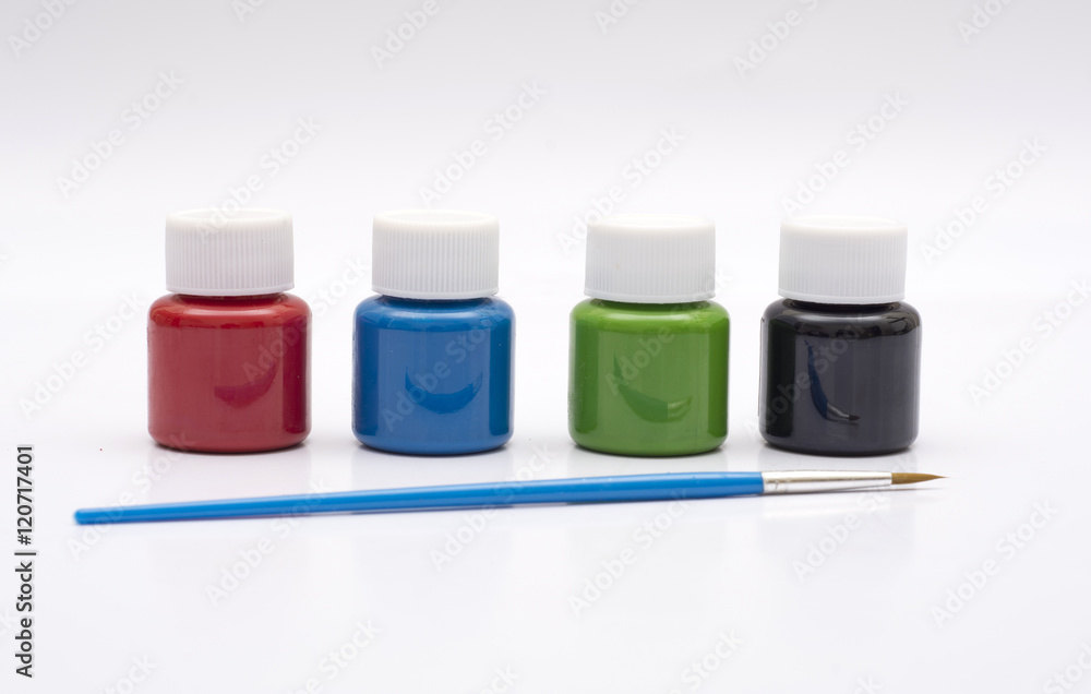 Four paint bottles in prime colors with painting brush Four paint bottles in prime colors with painting brush